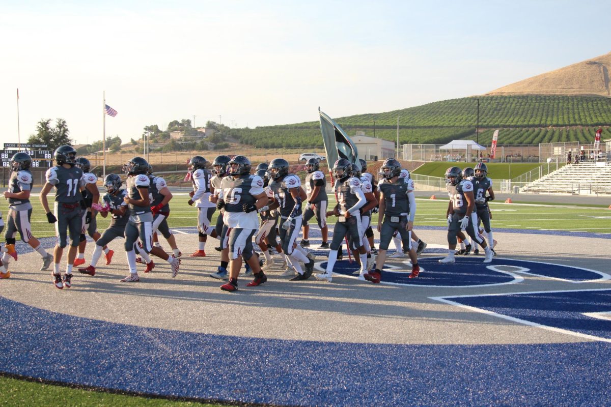 The Granite Hills football team breaks as it begins preparation for a football game earlier this season. 