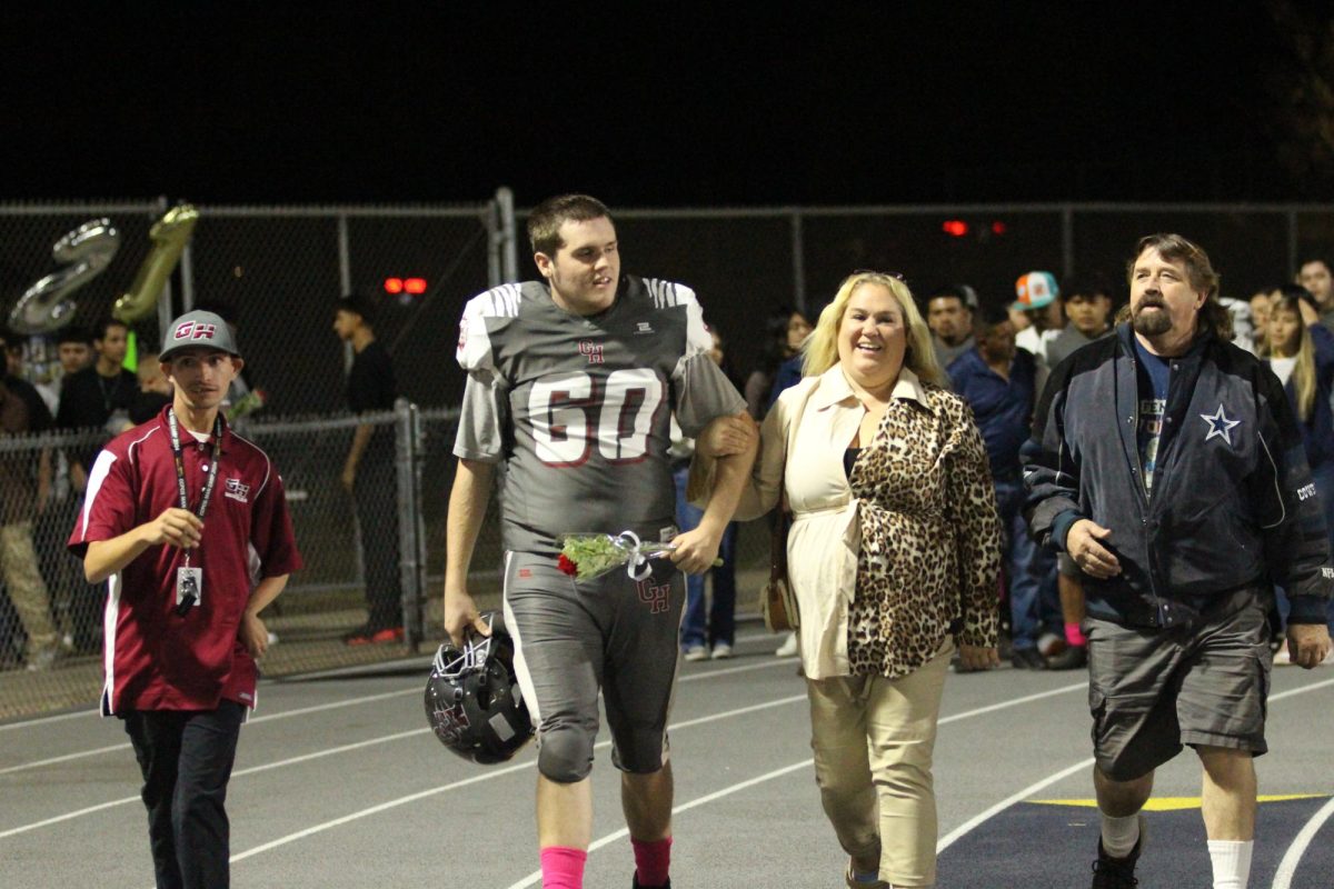 Nick Leichner walks on the track with his family before beating Lindsay on Senior Night on Oct. 25 at Jacob Rankin Stadium.