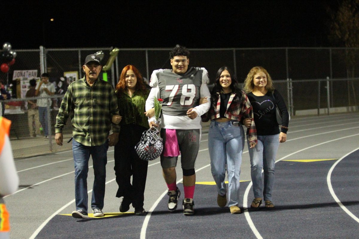 Antonio Moreno walks on the track with his family before beating Lindsay on Senior Night on Oct. 25 at Jacob Rankin Stadium.