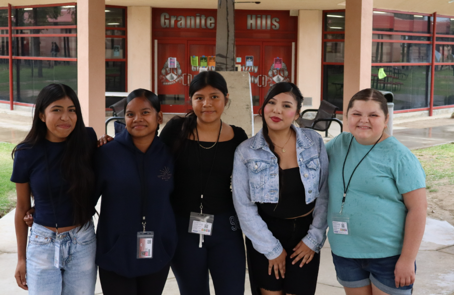 Five freshmen, who are a part of the ACE Pathway, pose for a photo in front of the Granite Hills LMC. 
