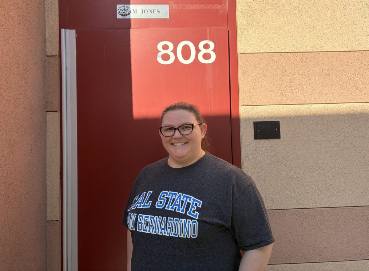 Ms. Jones poses for a picture outside her classroom. 